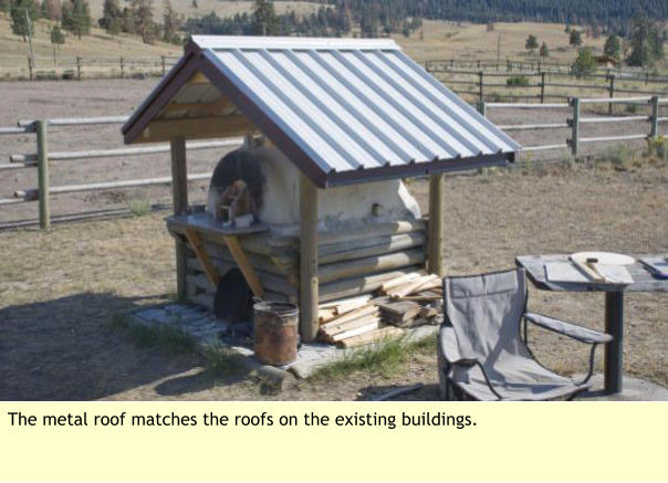 The metal roof matches the roofs on the existing buildings.